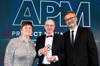 Nick Smallwood pictured with APM President Sue Kershaw and comedian Hugh Dennis